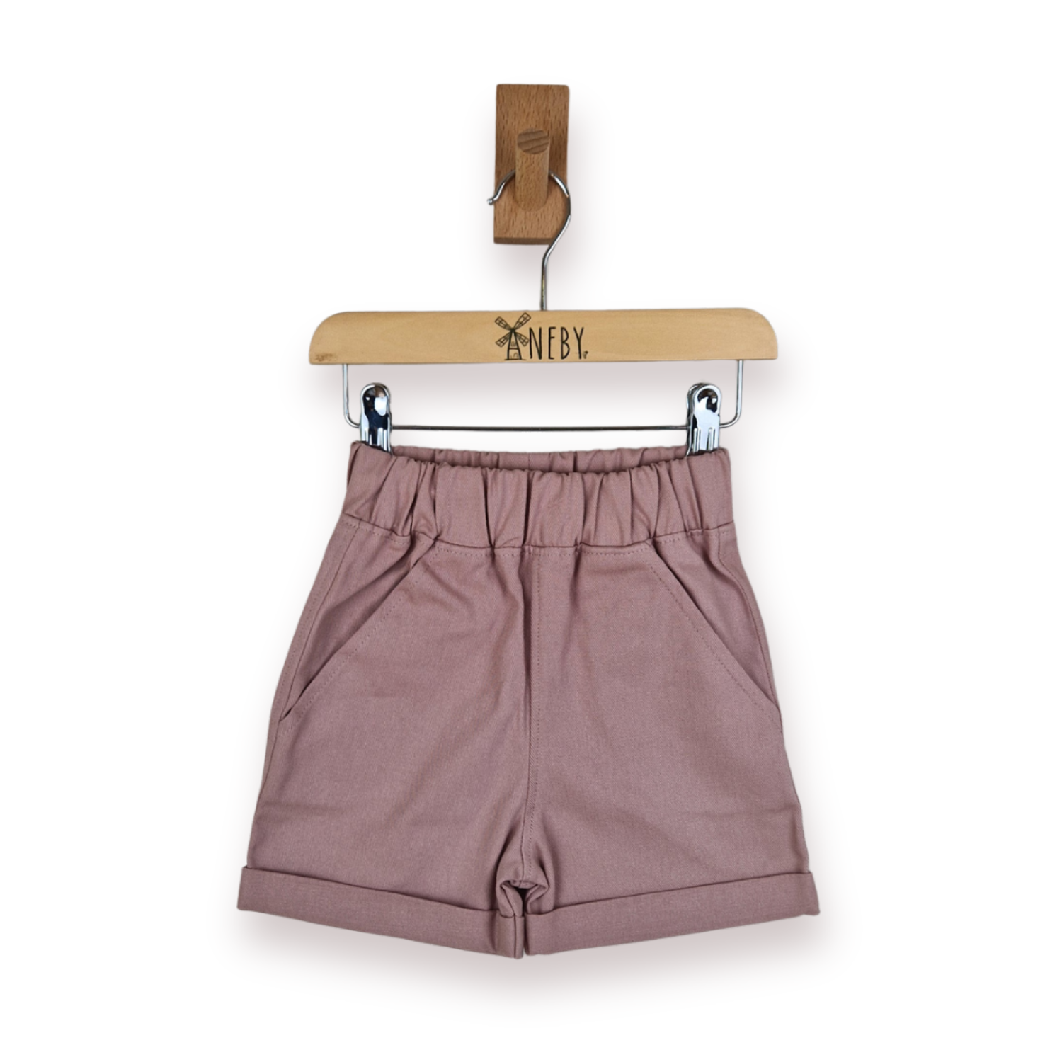 A pair of dusty pink shorts with an elastic waistband and rolled hems, hanging from a wooden hanger on a white background.