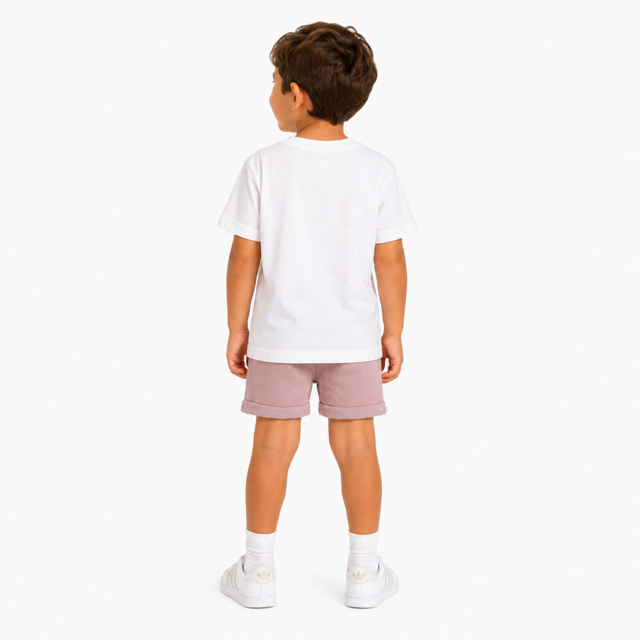 A child model shown from the back wearing a plain white short-sleeve t-shirt, dusty rose pink shorts, white socks, and white trainers against a clean white background.