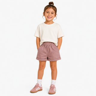 Pink Aneby chino shorts, being worn by a young girl.