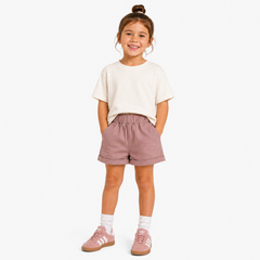 Pink Aneby chino shorts, being worn by a young girl.