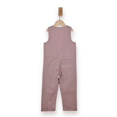 A sleeveless dusty rose jumpsuit hanging from a wooden hanger on a white background.
