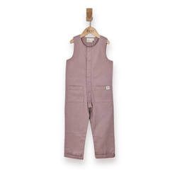 A sleeveless dusty rose jumpsuit for toddlers, hanging on a wooden hanger. The jumpsuit features a button-up front, two front patch pockets, and a small white brand tag on the left pocket.