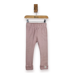 A pair of pink leggings for kids and toddlers, hanging from a wooden hanger on a white background.