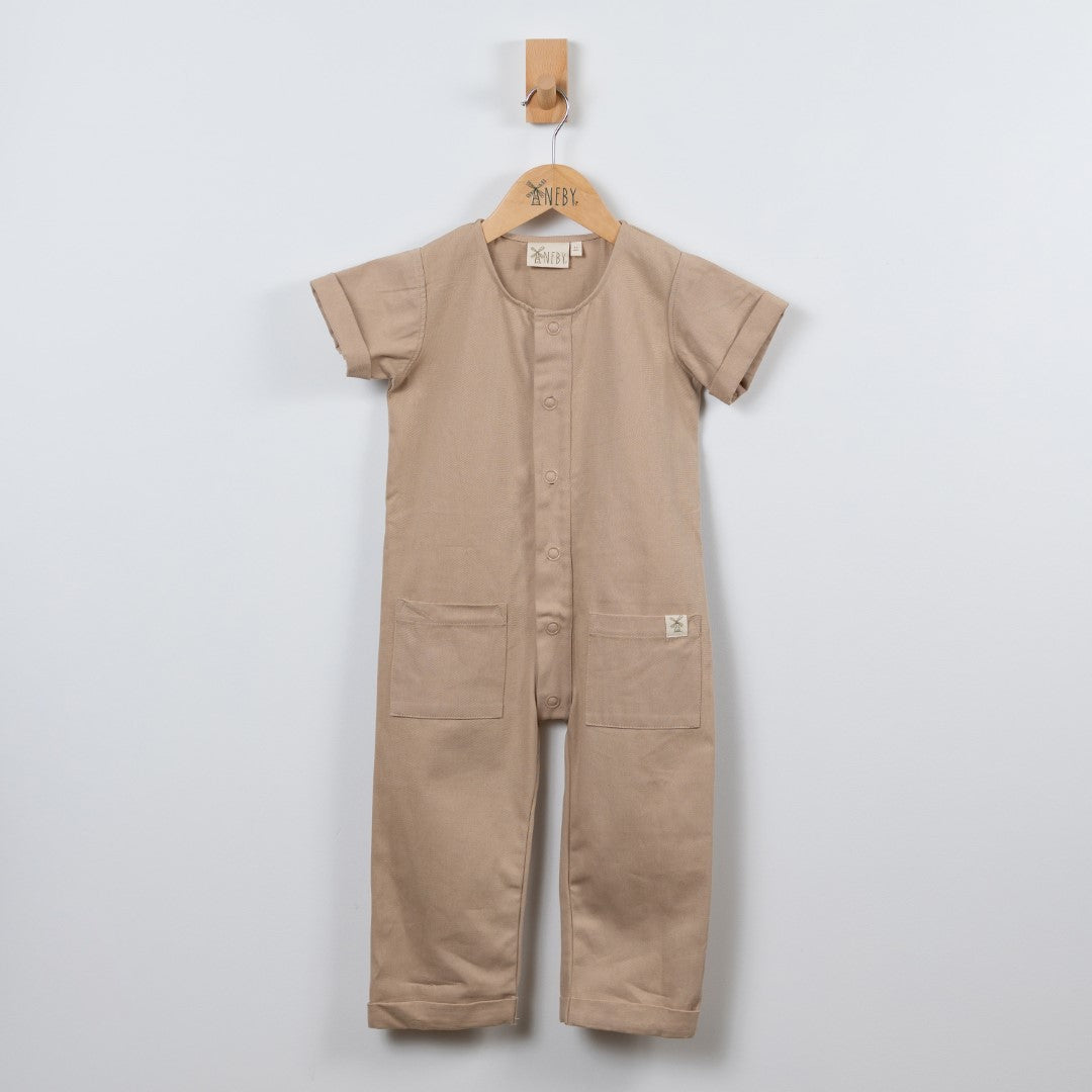 Oat beige jumpsuit with dyed to match poppers, patch pockets and rolled hem