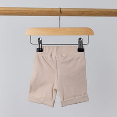 Rear view of cream cycle shorts with rolled hem