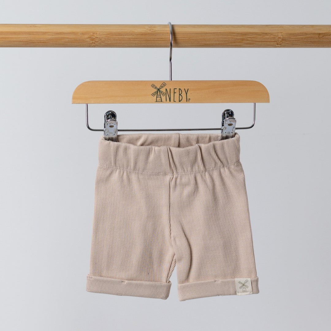 Shorts in neutral oat with Aneby hem tag on wooden hanger