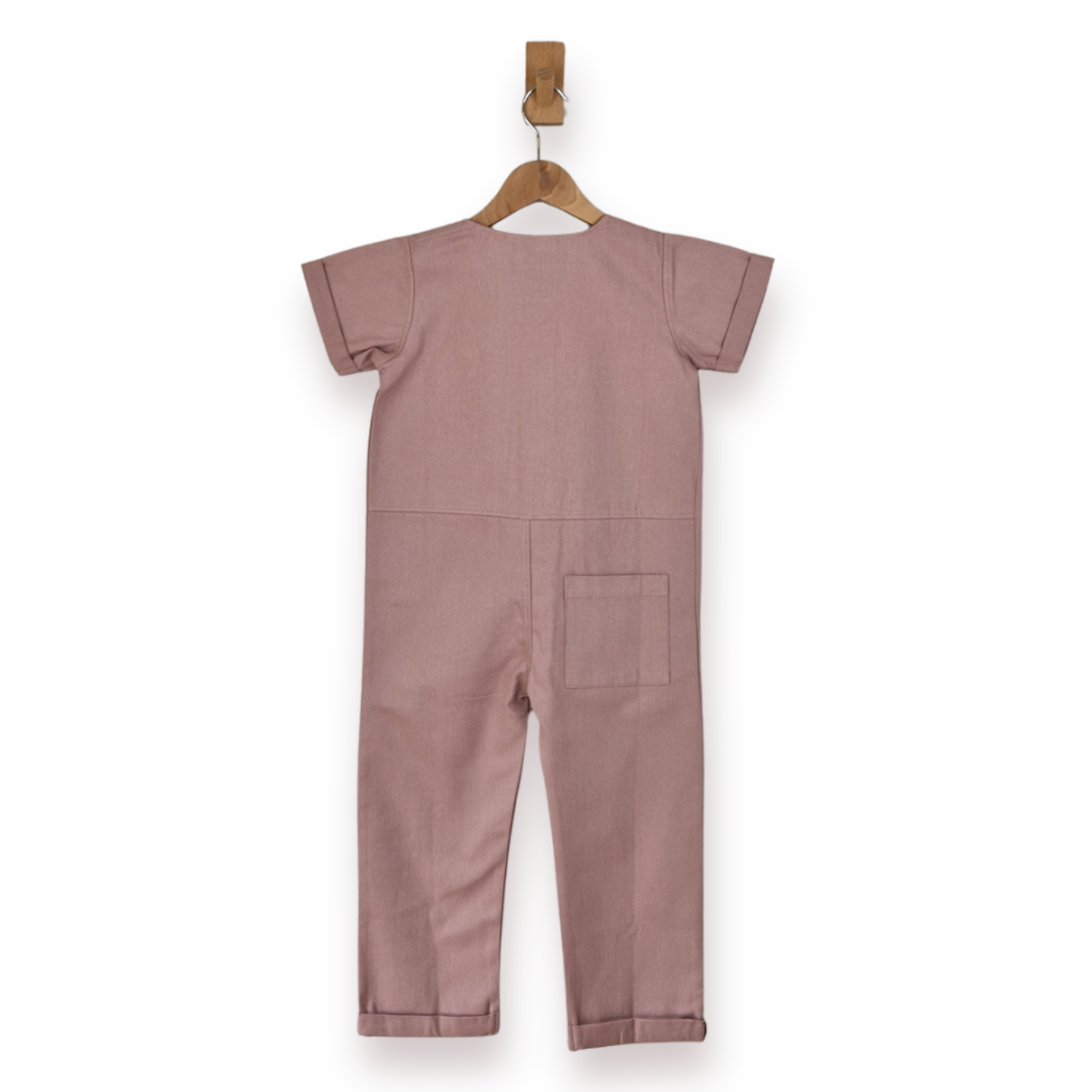 Pink short-sleeve one-piece jumpsuit hanging on a wooden hanger against a plain white background.