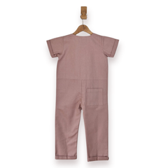 Pink short-sleeve one-piece jumpsuit hanging on a wooden hanger against a plain white background.