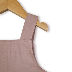 Back close up view of dusty pink kids' dungarees with patch pockets, designed for everyday play.