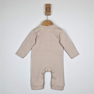 Beige ribbed cotton baby jumpsuit laid flat on a neutral background, showing the back design.