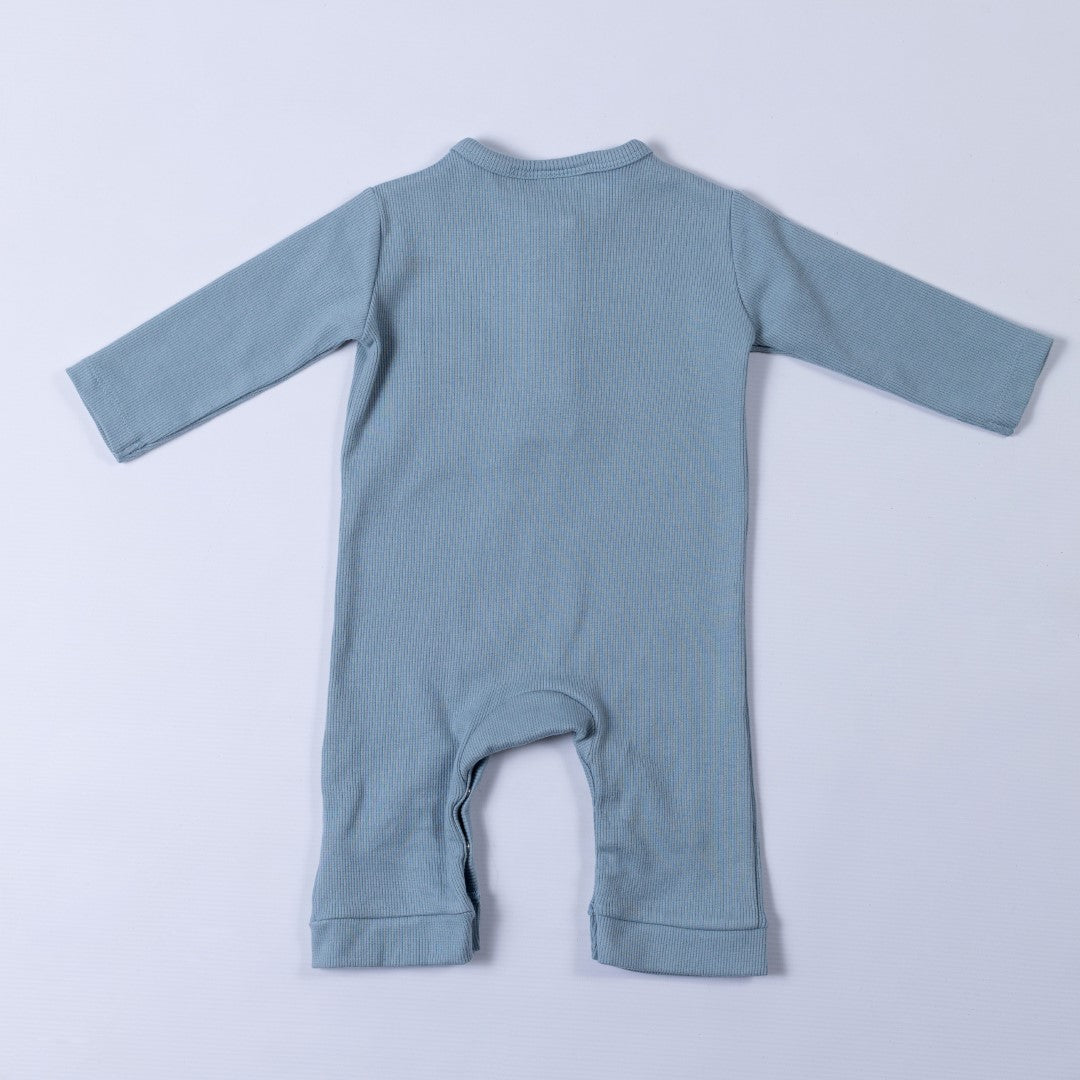 Slate blue ribbed cotton baby jumpsuit laid flat on a neutral background, showing the back design.