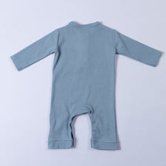 Slate blue ribbed cotton baby jumpsuit laid flat on a neutral background, showing the back design.