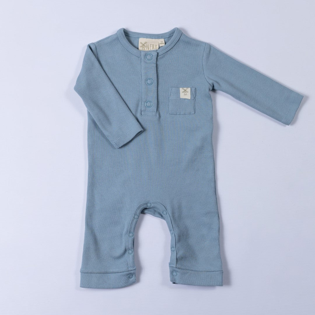 Slate blue ribbed cotton baby jumpsuit laid flat on a neutral background, showing the front design.