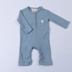 Slate blue ribbed cotton baby jumpsuit laid flat on a neutral background, showing the front design.