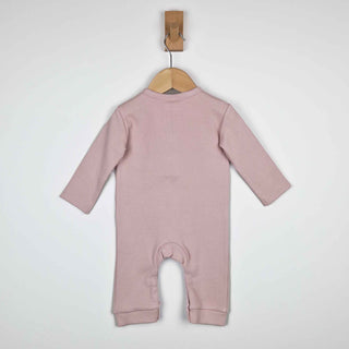 Dusty pink ribbed cotton baby jumpsuit laid flat on a neutral background, showing the back design.