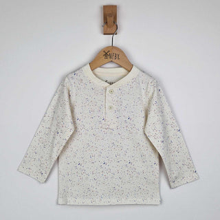 Flat lay of a kids long sleeve ecru t-shirt showing close-up detail of the speckled print and relaxed fit, neutral background. 
