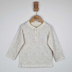 Flat lay of a kids long sleeve ecru t-shirt showing close-up detail of the speckled print and relaxed fit, neutral background. 