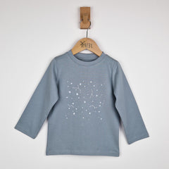 Flat lay of a kids long sleeve t-shirt with stars, displayed against a neutral background. The grey fabric features a scattered star pattern across the front.