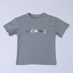 A kids abstract t-shirt laid flat, displaying its geometric pattern in earthy tones. The design features angular shapes arranged in a symmetrical layout.