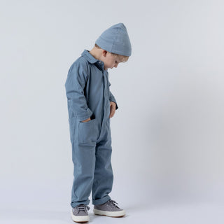 Slate blue children's boilersuit, front view, featuring soft organic fabric and chest pockets.