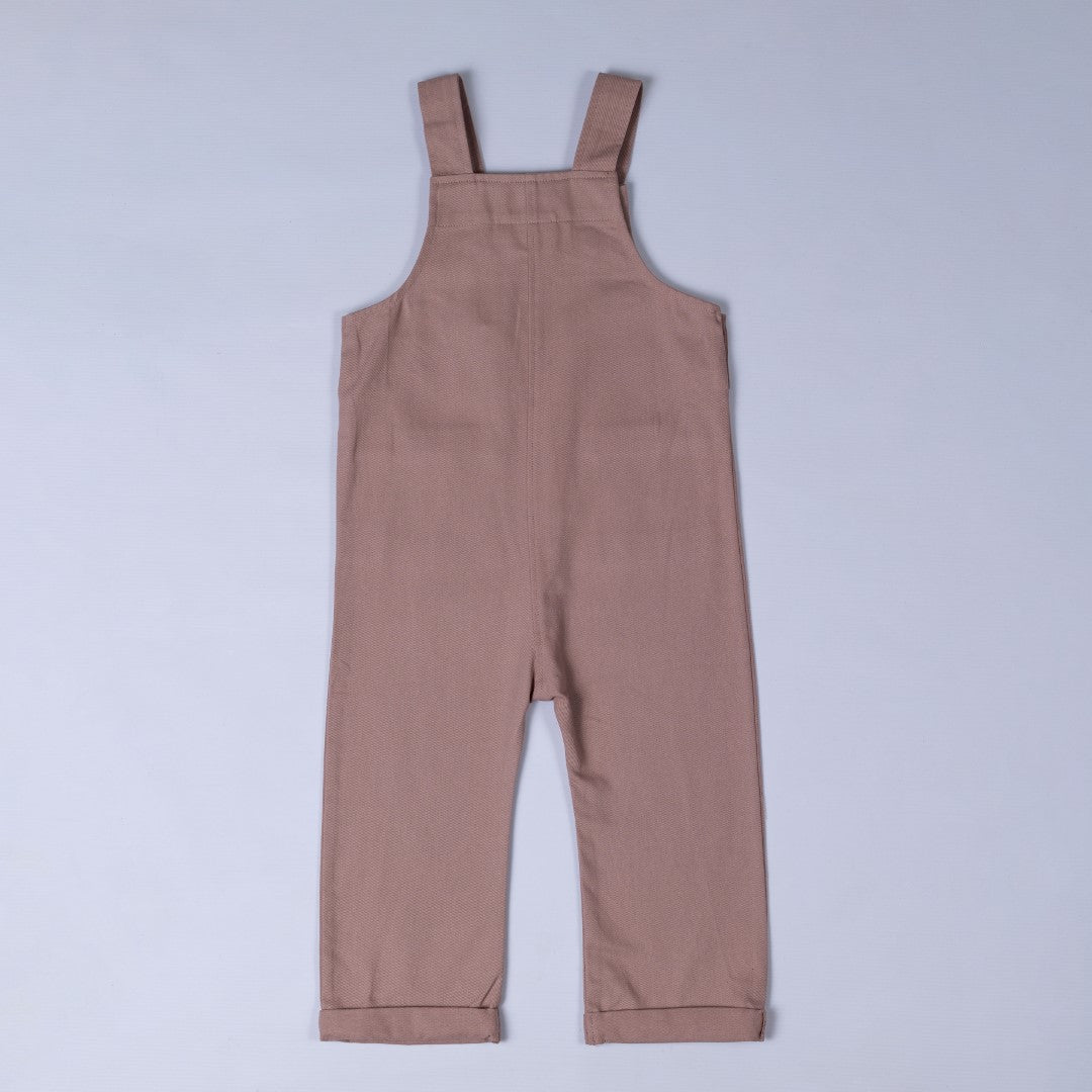 Back view of dusty pink kids' dungarees with patch pockets, designed for everyday play.