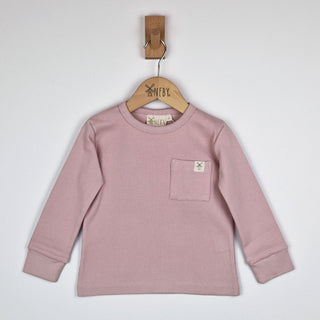 Front view of a dusty pink coloured kids long sleeve ribbed t-shirt on a neutral background.