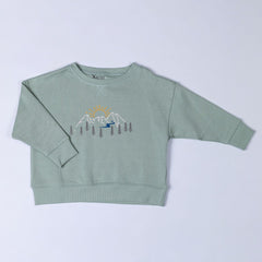 Front view of a sage green kids' sweatshirt with a mountain print. 