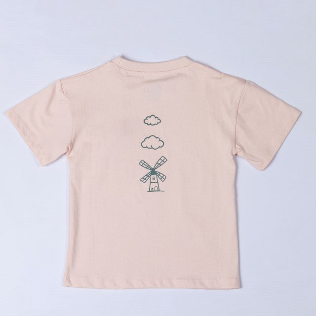 Flat lay of the back of a blush pink kids t-shirt, featuring the Aneby windmill logo with two small clouds above it.